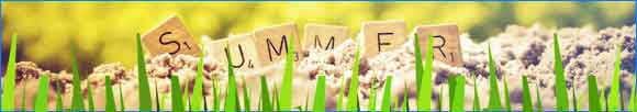 Banner with summer spelt out in scrabble tiles on sand